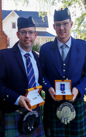 Andrew Hayes, winner of the Bar to the Medal, and Glenn Walpole, winner of the Gold Medal, with their prizes at the 2016 Piobaireachd Society Gold Medal (Canada) competition at Maxville, Ontario.