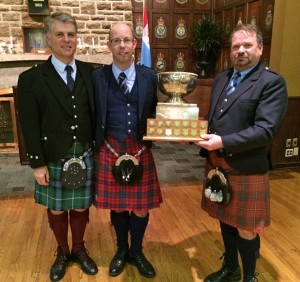 Andrew Hayes (middle) collects the 2014 Glengarry Cup from Jim Bush (right), with adjudicator Jack Lee.