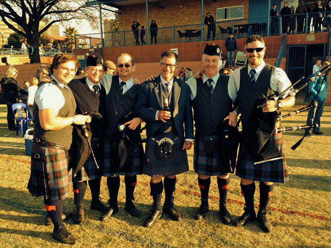 Members of the African Skye Pipe Band hang out with guest judge, Bob Worrall, after the contest.