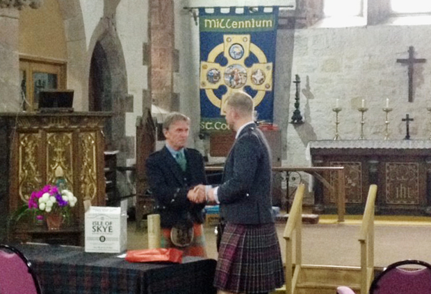 Cailean MacLean receiving his appreciation from the pipers after long service as Skye Gathering convenor.