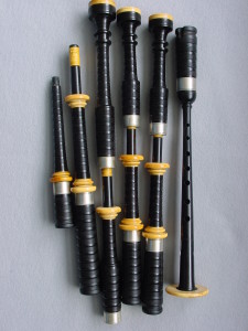 An early set of Duncan MacDougall pipes in cocuswood, with original chanter. Note the wide cord guides, particularly on the bass drone.
