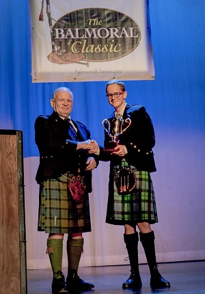 Gavin Mackay accepts the solo piping trophy at the 2015 Balmoral Classic.