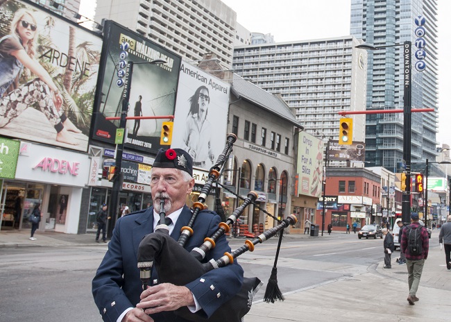 Former Grade 1 Toronto & District Pipe Band piper Jerry Fulton playing at the 2015 Rememberance Day event on Yonge Street, Toronto.