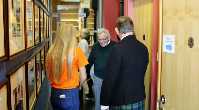 At the National Piping Centre's hallway with photos from each of the Grant's / Glenfiddich Championships since 1974.