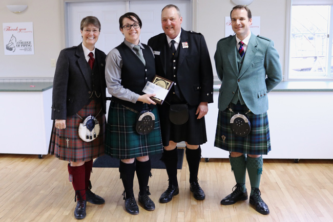 Katie Buckland (2nd left) accepts the 2016 Atlantic Canada MSR Challenge trophy from Atlantic Canada Pipe Band Association's Rick Crawford, with College of Piping & Celtic Performing Arts Director Karen Hatcher (far left) and adjudicator Alan Bevan.