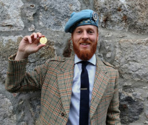 Nick Hudson with the Gold Medal for Piobaireachd, which he won at the Royal Braemar Highland Games this September. Hudson_Nice_Braemar2016_med