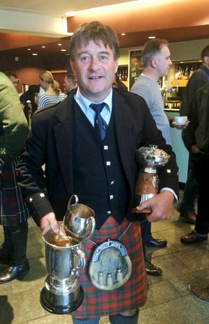 Angus J. MacColl with an armload of prizes from the 2016 Northern Meeting, including the quaich for best overall results.