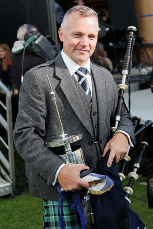 Inverarary & District Pipe-Major Stuart Liddell with the World Championship trophy.