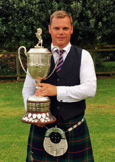 Stuart Easton with the overall Open Piping trophy from the 2018 Waipu Highland Games.