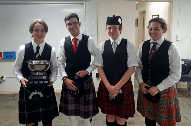 (L-R): Henry Paluch, Matthew Parsons, Caleb MacPherson and Kathleen Lasseter with the John Wilson Memorial Trophy.