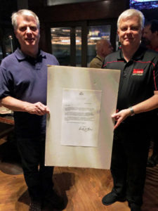 Jack and Terry Lee holding an enlarged letter of welcome from then New York City Rudy Giuliani.