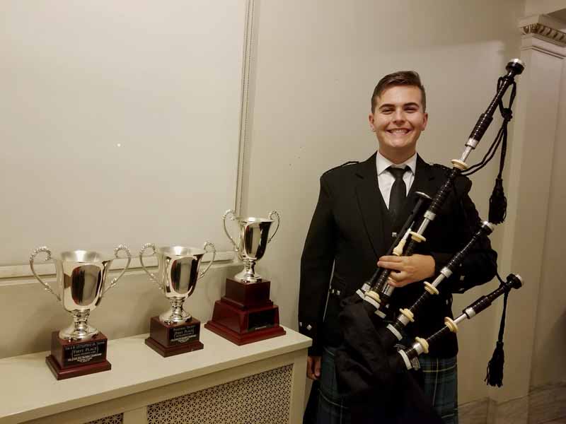 Charlie Morris with his trophies and prize pipes from McCallum Bagpipes.