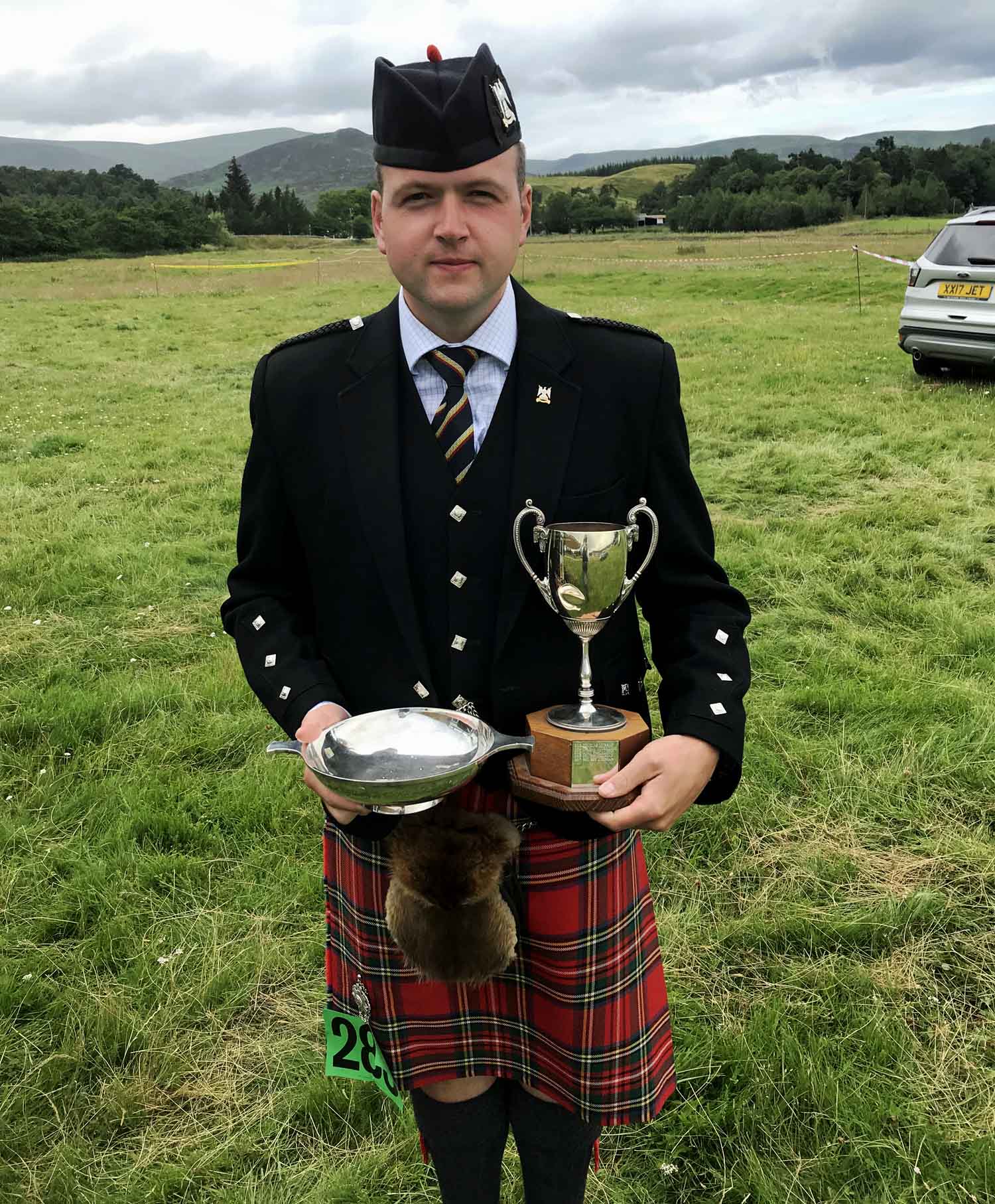 Ben Duncan with the Champion Piper trophies at the 2019 Newtonmore Games.