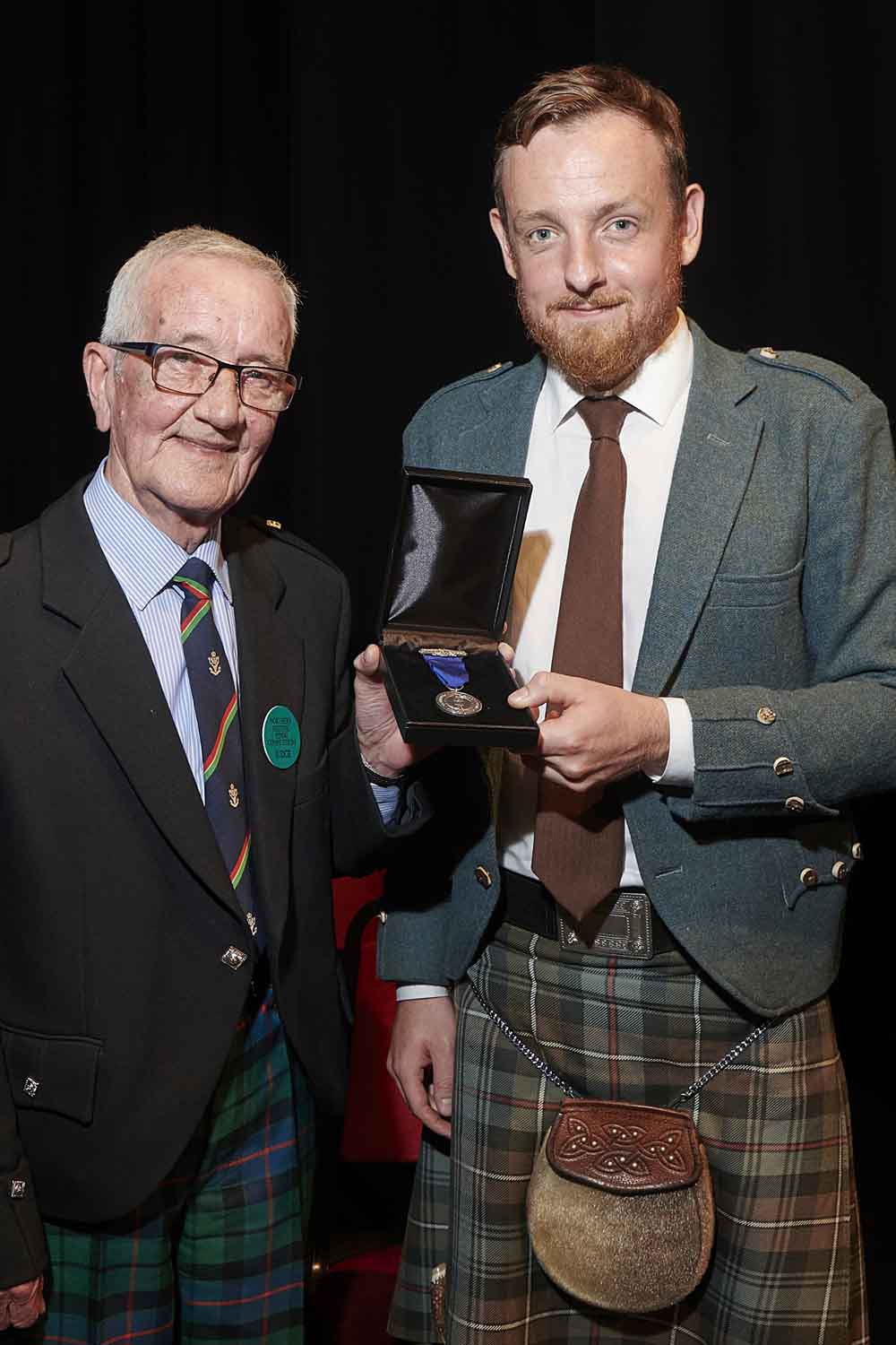 Iain Morrison (left) with his pupil James Duncan Mackenzie after MacKenzie won the Highland Society of London's Gold Medal at the 2019 Northern Meeting.