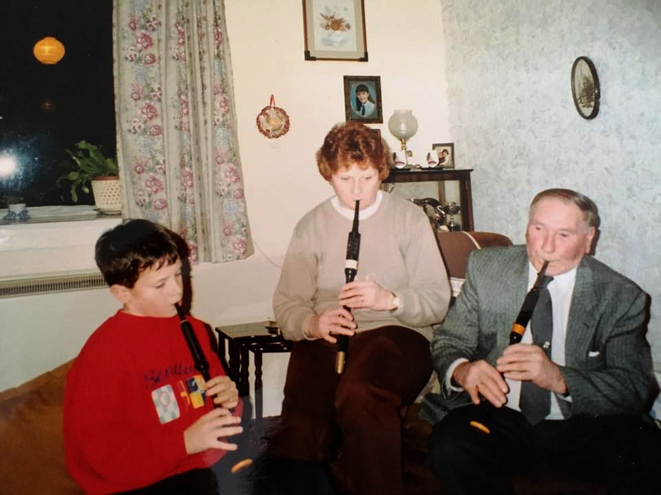 A younger Finlay Johnston in a chanter practice with his mother, Anne, and grandfather, Alasdair Sinclair, Greenhill, Isle of Tiree.
