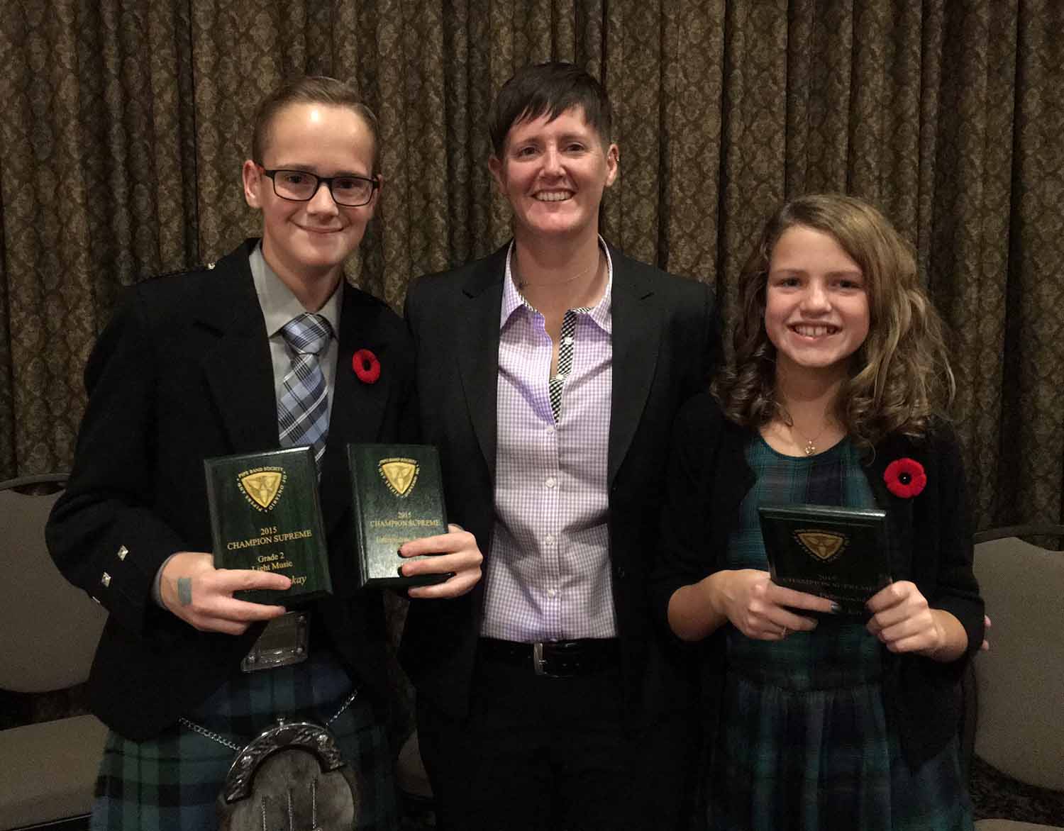 Piping runs strong in the Mackay family. Third generation Mackay pipers Gavin and Drew celebrate their 2015 Champion Supreme awards at the PPBSO's annual gala with their aunt Lynda.