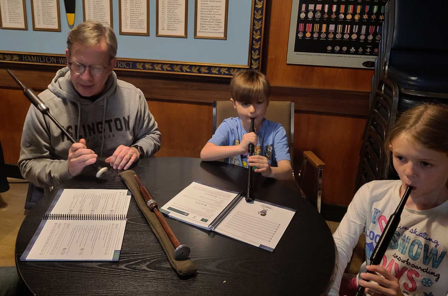 Peter Aumonier working with beginner pipers as part of the Hamilton Police Pipe Band's reinvigorated teaching program.