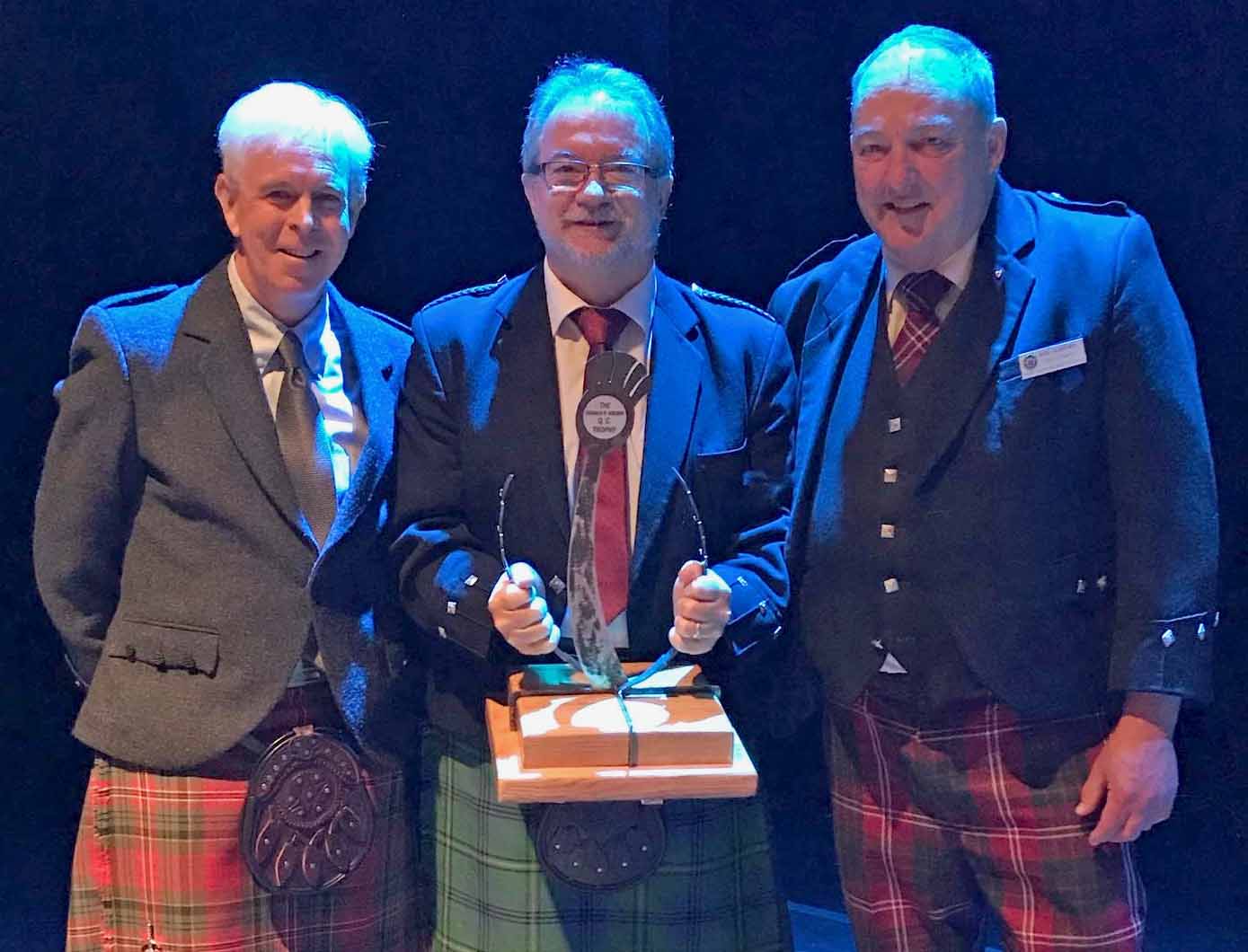 Bruce Gandy (middle) with the Donald R. Brown QC Trophy for light music – "the thistle trophy" – at the Atlantic Canada Challenge, judge Doug Boyd (left) and Atlantic Canada Pipe Band Association supremo Rick Crawford (right).
