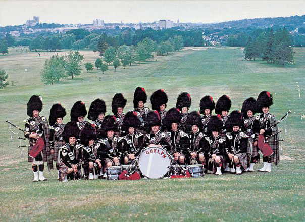 The band's 1978 album cover shot, taken on the fairway of a local golf course. Pipe-Major Ed Neigh is far left, and Pipe-Sergeant Jim McGillivray is at far right. Lead-Drummer Larry Willis is furthest left in the front row. Other notables include Greg Abbott, Bruce Anderson, John Bottomley, Melanie McGillivray and Ellen Mole.