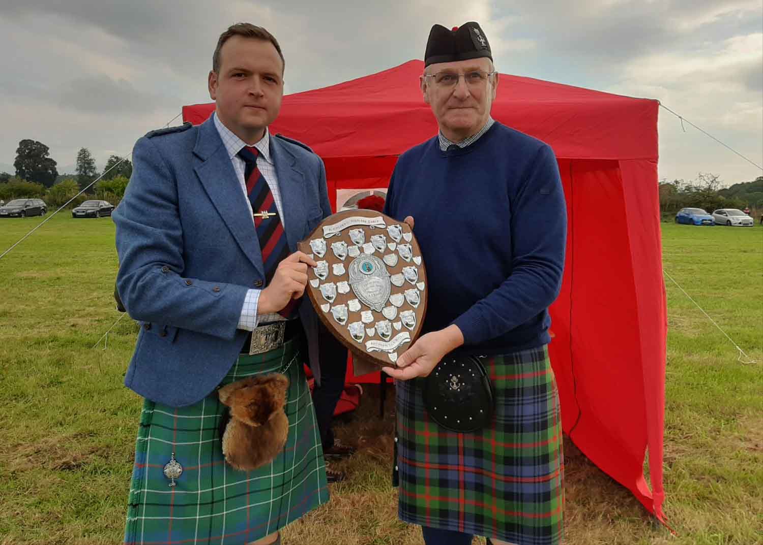 Ben Duncan getting the overall trophy from Stuart Samson at the 2022 Blairgowie & Rattray Highland Games.