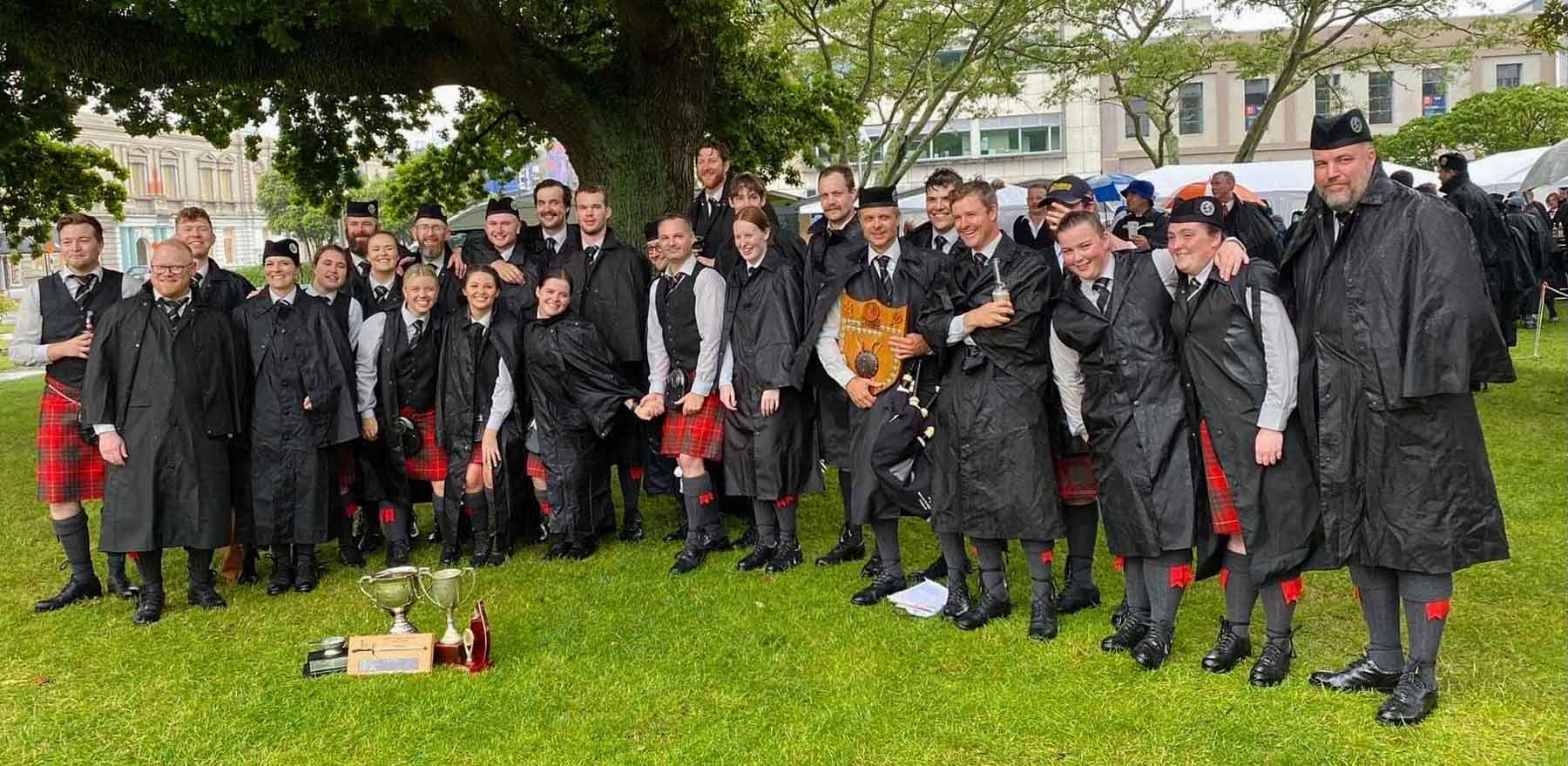 Manawatu Scottish celebrate their eight first-place rankings at the 2022 Jenny Mair Square Day competition in Palmerston North, New Zealand.
