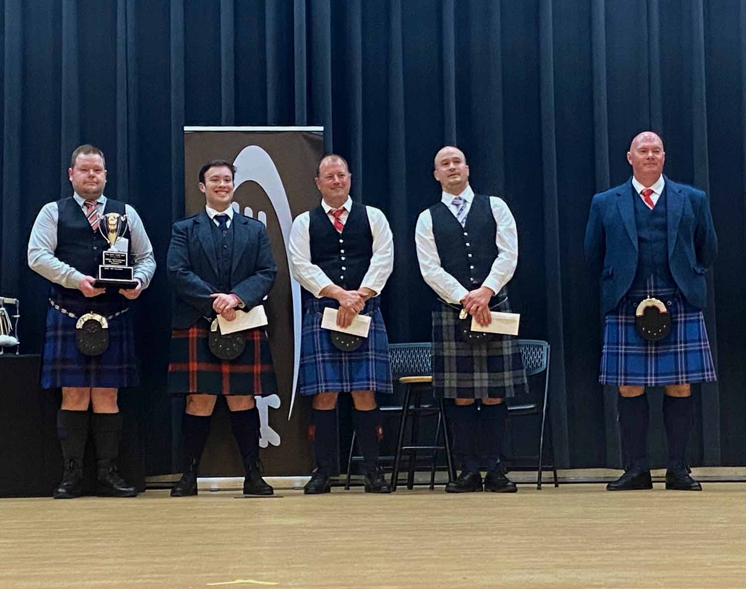 Winner of the Intercontinental Solo Drumming Championships (L-R): Derek Cooper, Blair Beaton, Eric MacNeill and Alex Kuldell, with organizer Iain Donaldson at far right.