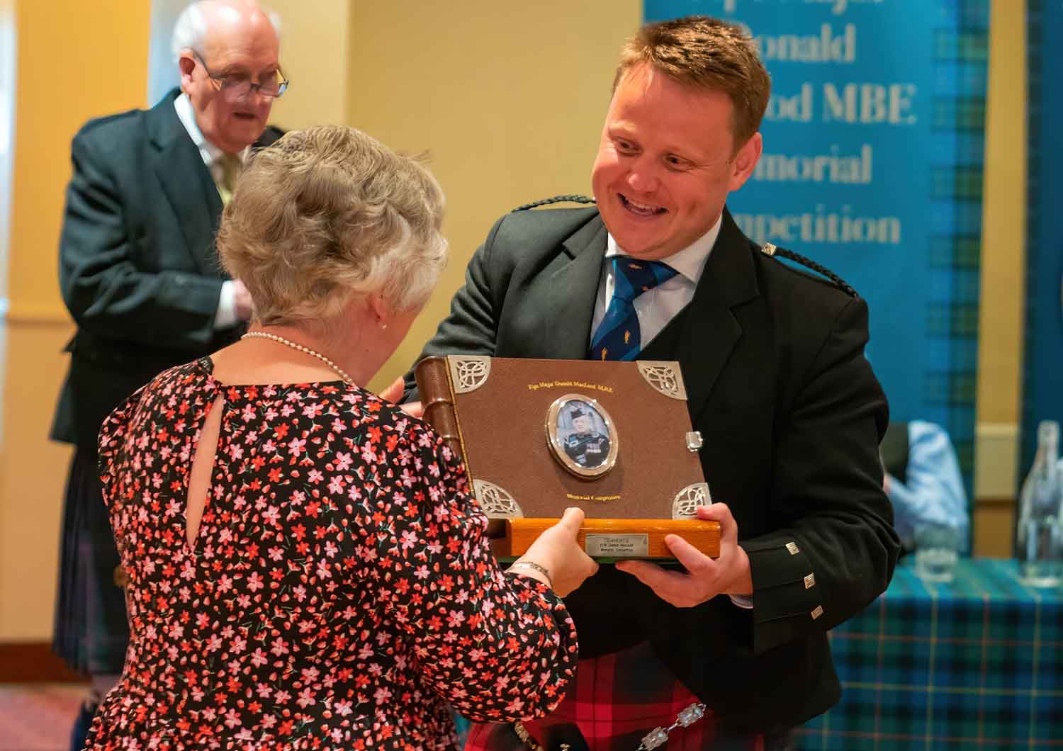 Callum Beaumont receiving the overall trophy at the 2023 P-M Donald MacLeod Memorial from Susan Millar (nee MacLeod).