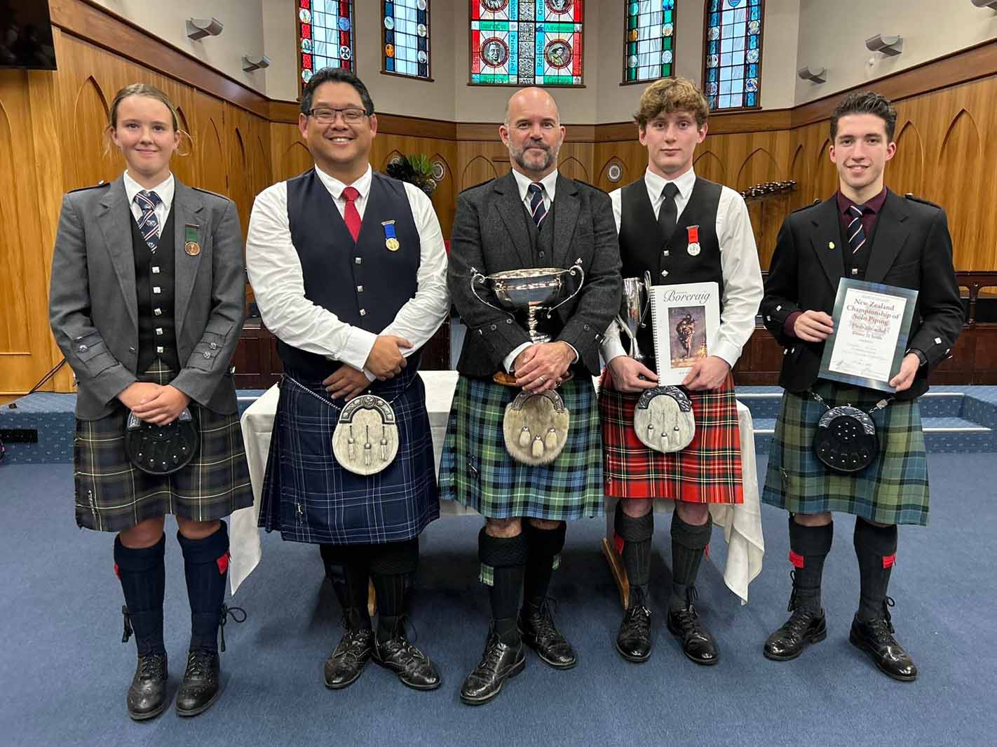 L-R: Bronze Medallist Maggie McConnochie, Gold Medallist Jono Quay, Gold Clasp winner Brendon Eade, Silver Medallist Matthew Cresswell, and Under-21 NZ Piobaireachd winner Campbell Wilson.