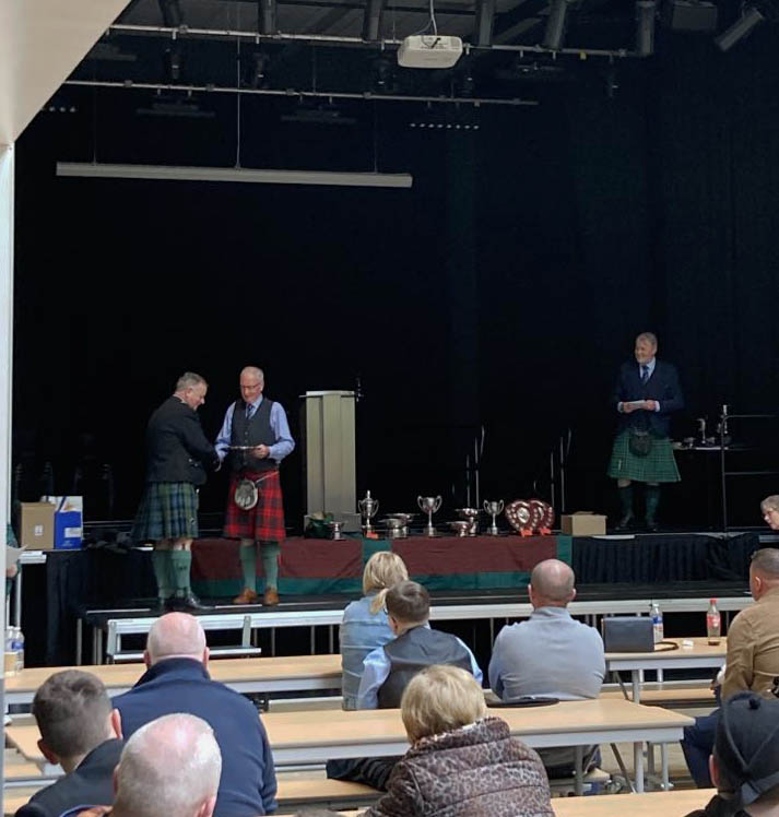 Roddy MacLeods accepts the Piobaireachd trophy at the 2023 Highlands & Islands solo competitions.