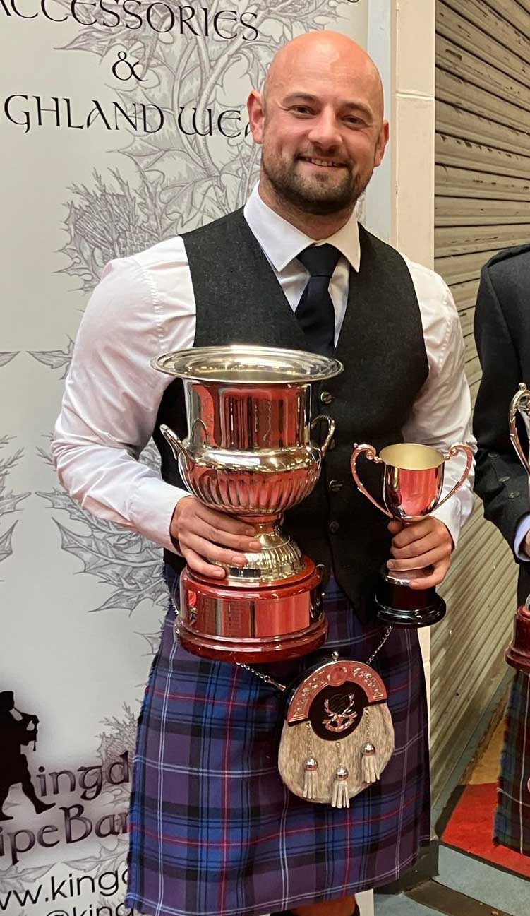 Steven Shedden with his solo drumming trophies from the 2023 Kingdom Thistle European Solo Drumming Championships.