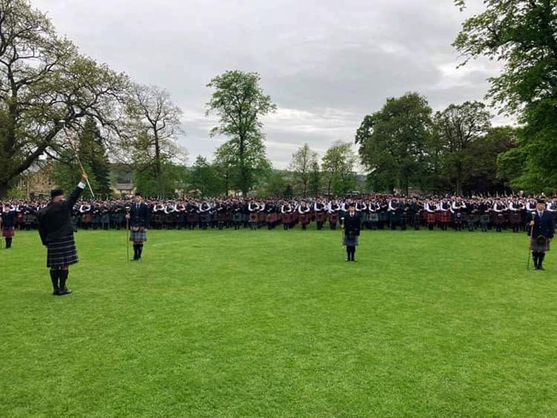 The massed bands scene at the close of the first Dollar Pipe Band Competition.