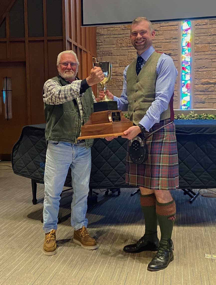 Ian Swinton presents the overall trophy to Derek Midgley.