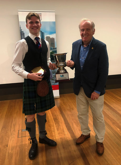 William Mullighan (left) is presented with the B-Grade Victorian Champion trophy.