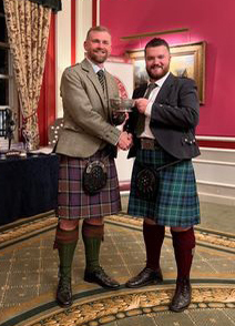 Angus MacPhee (right) receives the CPA Leage Table Championship trophy for most aggregate points in 2023 across all designated UK events.