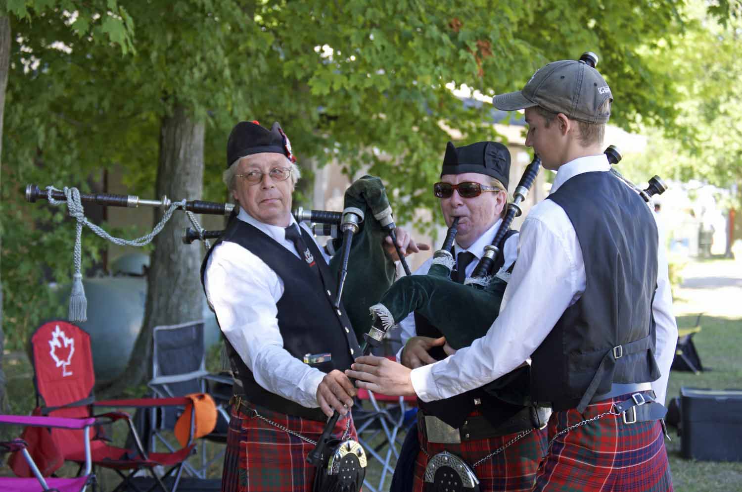 Bruce Anderson, left, adjusting chanters at a competition in Ontario.