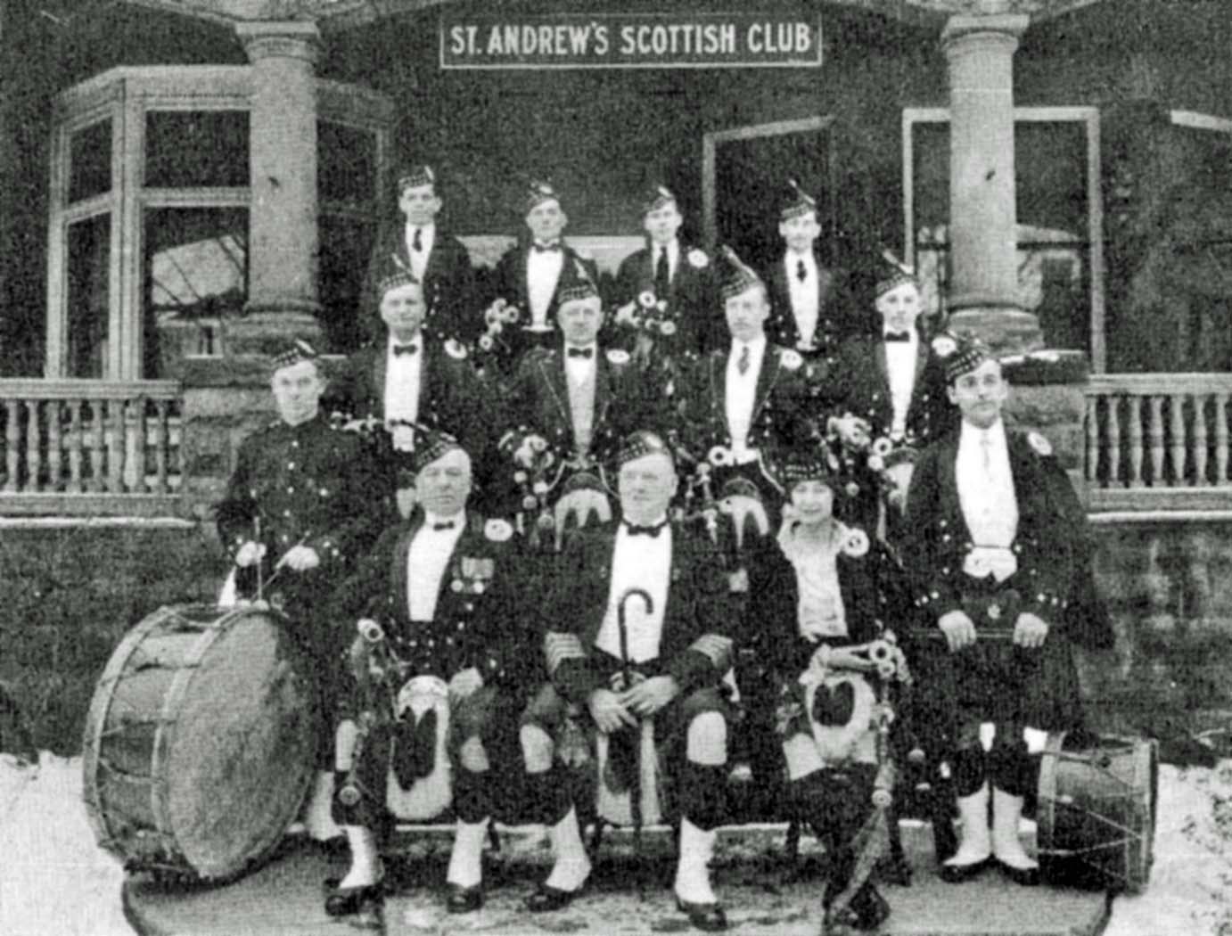 An assembly of pipers and drummers at the Buffalo, New York, St. Andrew's Scottish Club, 1921. Mona Ross is seated front right.