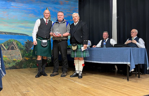 Alen Tully (left) receives the Medley trophy.