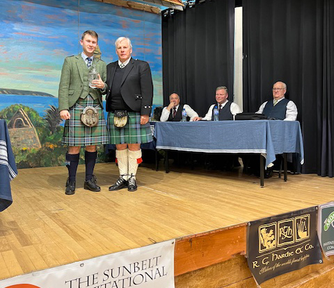 Ardmore Cup champion Connor Sinclair (left) and organizer Eric Stein, with judges looking on.