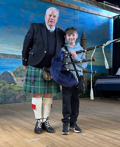 Ben Cardy receives his new R.G. Hardie Henderson pipes from Eric Stein.