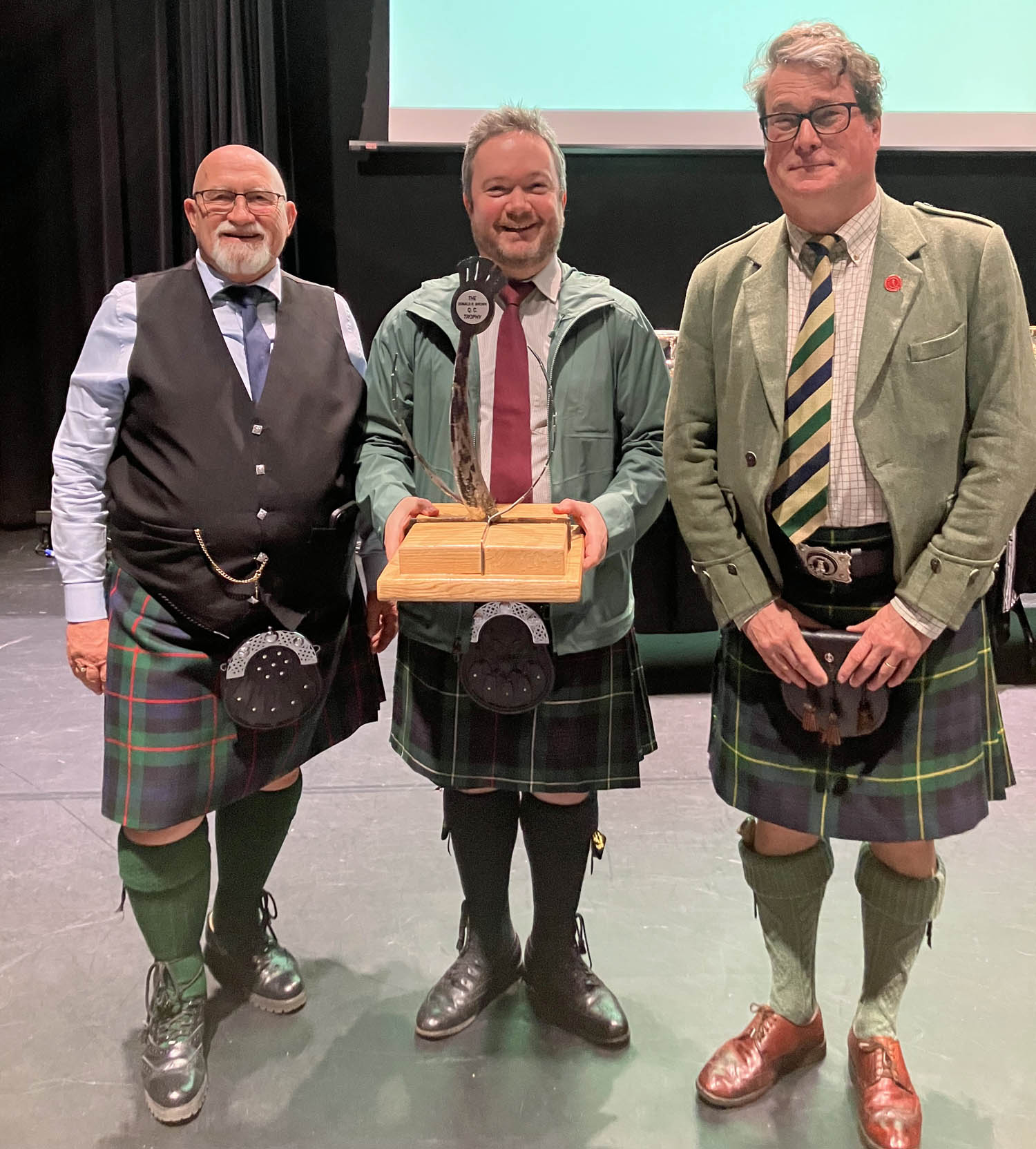 Alex Gandy (centre) receives the MSR trophy from ACPBA Chief Steward Gordon Murray (left) and judge Andy Rogers.
