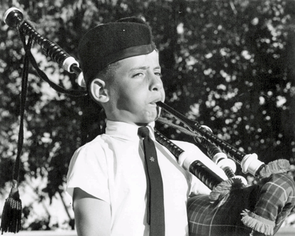 July 1967. My dad was appointed to the Queen’s Bench Judiciary in 1964, and they decided to celebrate in 1967 with a garden party. I was welcoming guests. Note the Canadian Centennial logo tie pin, and the full-length blowpipe.