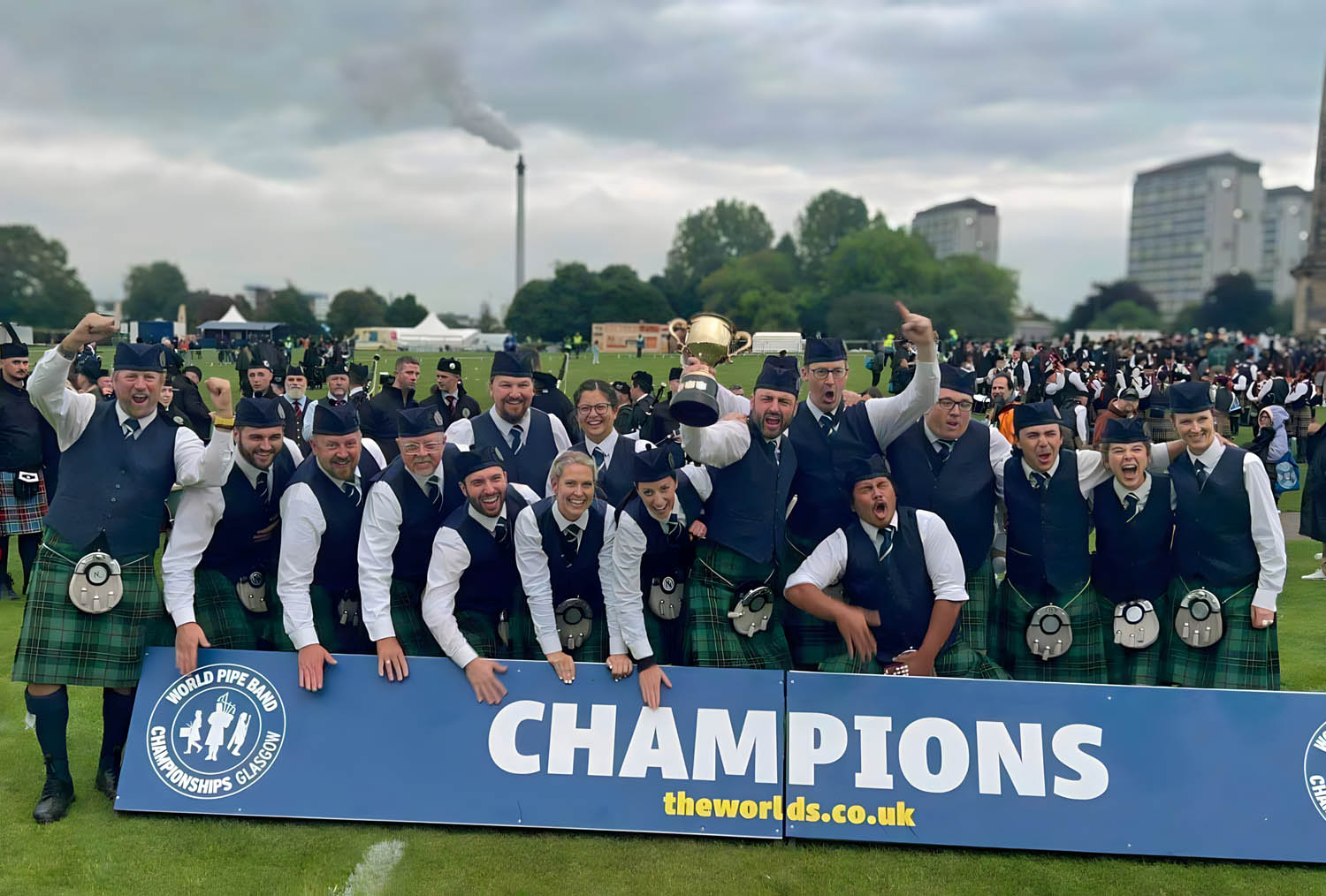 North Stratton's drum section celebrates their Grade 2 World Pipe Band Drumming victory at Glasgow Green, August 2024.