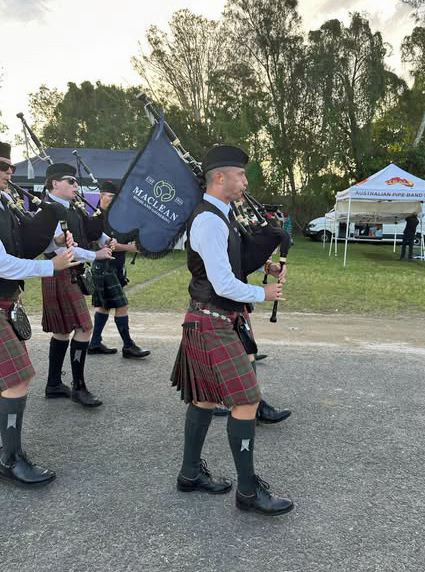 St. Andrew's Queensland and P-M Greg McAllister playing off the field with the newly awarded P-M Sandy Campbell banner, who passed away in 2024.