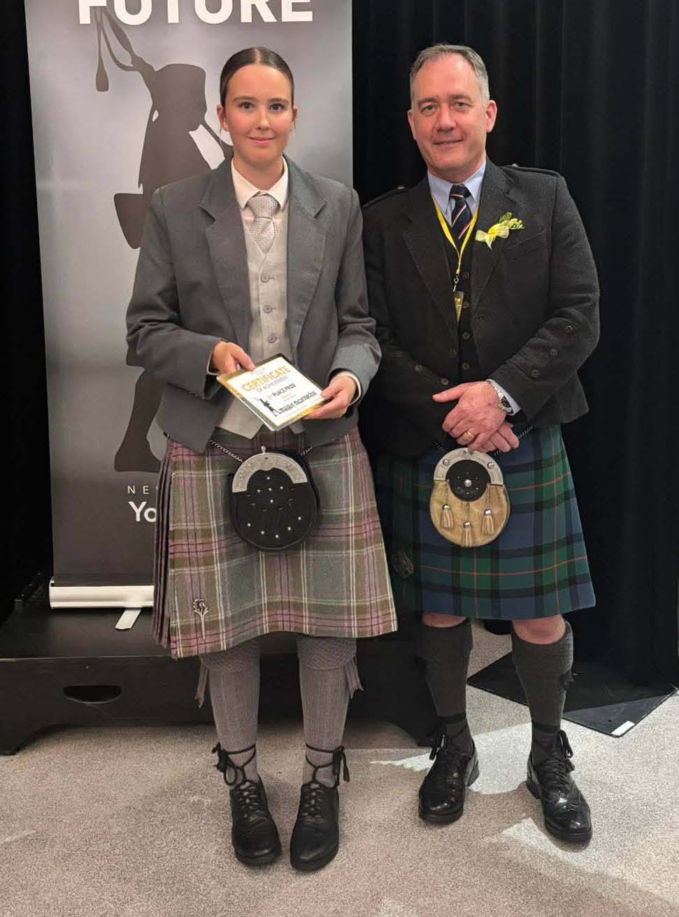 2025 NZ Piper of the Year runner-up Maggie McConnochie with judge Greg Wilson