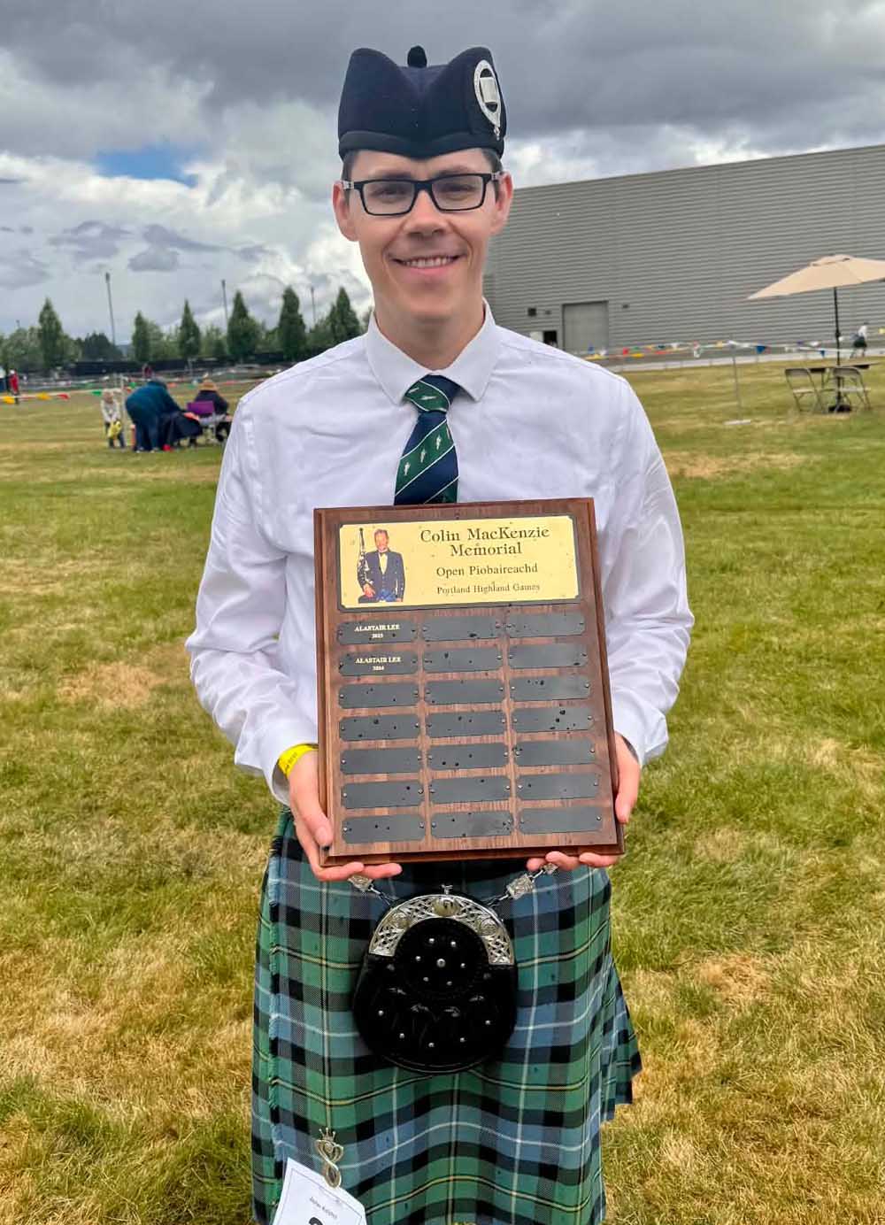Zephan Knichel agreeing it was worth the wet effort to gain the Colin MacKenzie Memorial Trophy for the Open Piobaireachd and the aggregate Open Solo Piping award.