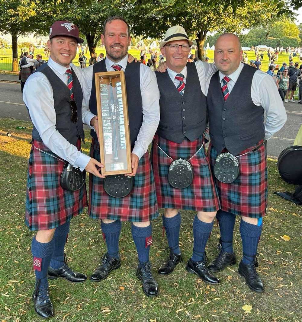 Police Scotland Fife leaders celebrate success at the 2025 World Championships (L-R): P-M David Wilton, P-S Greig Canning, L-D Mick O'Neill, and flank snare drummer Iain Rae.