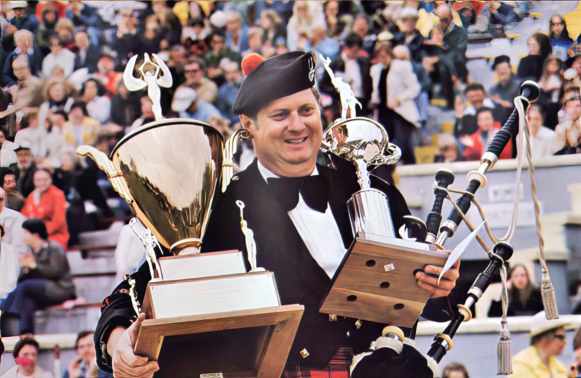 Pipe-Major Gordon Tuck with the United States Championship trophies at the Alma Highland Games.