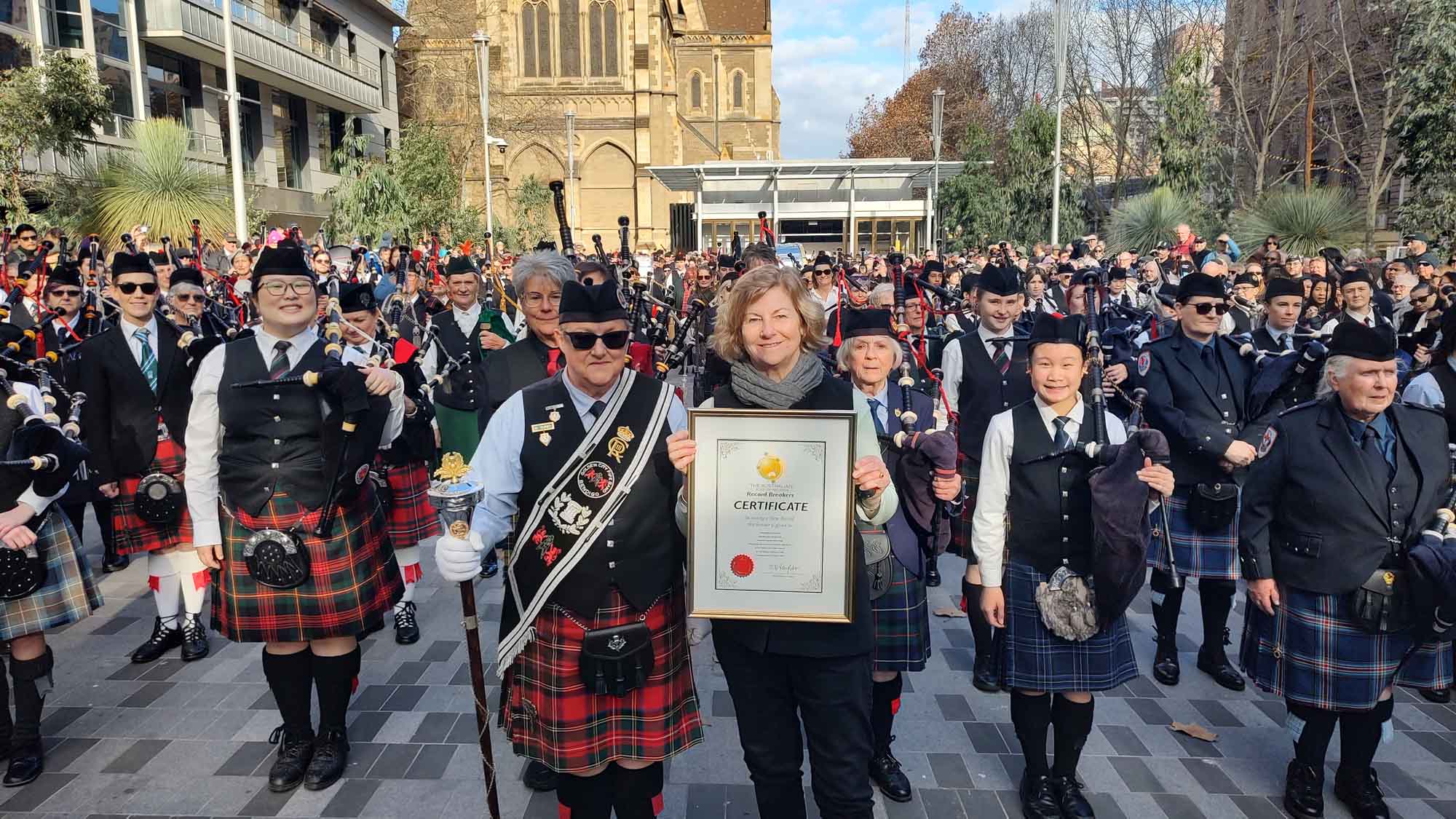 The 145-strong all-female pipe band with their official Australian Record certificate at Melbourne Square, July 5, 2026.