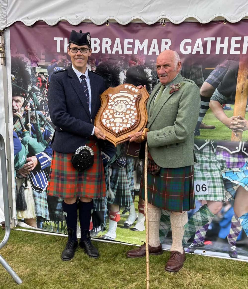 Zephan Knichel receives the trophy for best overall piper at the 2026 Braemar Gathering