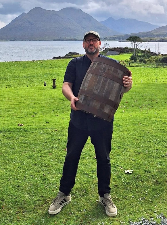 Gary West shows off his cask strength by hoisting his Raasay Distillery prize for winning the Dance Music event at the Raasay Restitution